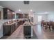 Open kitchen featuring stainless steel appliances, dark cabinets, granite countertops, and an island with seating at 938 Mansfield Rd, Tavares, FL 32778