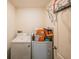 Functional laundry area includes a washer, dryer, and overhead basketball hoop at 938 Mansfield Rd, Tavares, FL 32778