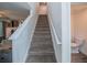 Carpeted staircase with white railing leads to the upper level of the home at 938 Mansfield Rd, Tavares, FL 32778