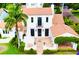 Stunning aerial view of a white Spanish-style home showcasing the red tile roof and manicured landscaping at 1234 W Ivanhoe Blvd, Orlando, FL 32804