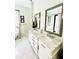 Bathroom featuring a soaking tub with floor mounted faucet and dual sinks with marble countertops at 1234 W Ivanhoe Blvd, Orlando, FL 32804