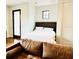 Cozy bedroom featuring a woven headboard, white linens, and a small window for natural light at 1234 W Ivanhoe Blvd, Orlando, FL 32804