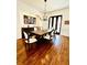 Formal dining room with hardwood floors, modern chandelier, and seating for six, perfect for entertaining at 1234 W Ivanhoe Blvd, Orlando, FL 32804