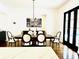 Bright dining area with hardwood floors, modern lighting, seating for six, and access to the kitchen at 1234 W Ivanhoe Blvd, Orlando, FL 32804