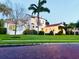Stunning exterior view of a Spanish-style home with mature landscaping and a well-manicured lawn at 1234 W Ivanhoe Blvd, Orlando, FL 32804