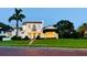Elegant two-story home boasts a red tile roof, lush landscaping, and a charming brick walkway leading to the entrance at 1234 W Ivanhoe Blvd, Orlando, FL 32804
