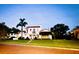 The stately two-story home features a red tile roof, lush landscaping, and a well-manicured front lawn at 1234 W Ivanhoe Blvd, Orlando, FL 32804