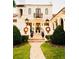 Beautiful two-story home with a landscaped yard, festive decorations, and a charming fountain at 1234 W Ivanhoe Blvd, Orlando, FL 32804