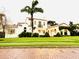 Charming white two-story home featuring a red tile roof and a lush green lawn with a mature palm tree at 1234 W Ivanhoe Blvd, Orlando, FL 32804