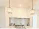 Modern kitchen features a stainless steel range hood, decorative tile backsplash, and pendant lighting at 1234 W Ivanhoe Blvd, Orlando, FL 32804