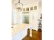 Modern kitchen with white cabinets, stainless steel appliances, and glass-front display cabinets at 1234 W Ivanhoe Blvd, Orlando, FL 32804