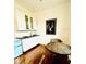 Compact kitchenette with white cabinets, black countertops, and a retro-style mini fridge at 1234 W Ivanhoe Blvd, Orlando, FL 32804
