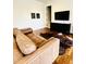Comfortable living room with a leather couch, hardwood floors, and a large television at 1234 W Ivanhoe Blvd, Orlando, FL 32804