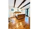 Spacious main bedroom with wood beams, dark trim windows and doors, and hardwood flooring at 1234 W Ivanhoe Blvd, Orlando, FL 32804