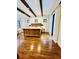 Spacious main bedroom featuring hardwood floors, wood-beam ceilings, and a large bed, and French doors at 1234 W Ivanhoe Blvd, Orlando, FL 32804