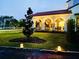 Outdoor living space with a covered patio, inviting seating, and festive lighting with lush lawn at 1234 W Ivanhoe Blvd, Orlando, FL 32804
