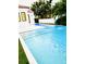 The backyard pool offers a refreshing escape, set against the backdrop of a modern home and manicured lawn at 1234 W Ivanhoe Blvd, Orlando, FL 32804