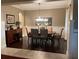 This dining room boasts hardwood floors, wainscoting, and a decorative chandelier at 1446 Vivaldi Pl, Longwood, FL 32779