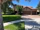 Charming home features a manicured lawn, brick driveway, and a tile roof at 1446 Vivaldi Pl, Longwood, FL 32779