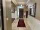Inviting foyer with a dark wooden door, decorative rug and stylish accents at 1446 Vivaldi Pl, Longwood, FL 32779