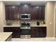 The kitchen is equipped with stainless steel appliances, granite countertops, and dark wood cabinetry at 1446 Vivaldi Pl, Longwood, FL 32779