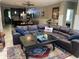 Spacious living room features a leather sectional sofa, ceiling fan and decorative area rug at 1446 Vivaldi Pl, Longwood, FL 32779