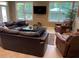 Relaxing living room includes a leather sectional, comfortable armchairs, and natural light at 1446 Vivaldi Pl, Longwood, FL 32779