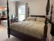 Main bedroom with a four poster bed and an ensuite bathroom at 1446 Vivaldi Pl, Longwood, FL 32779