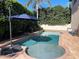 Backyard pool with a spa, brick patio, and tropical landscaping at 1446 Vivaldi Pl, Longwood, FL 32779