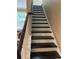 A staircase with black stained treads and white risers leading to the upper level at 1446 Vivaldi Pl, Longwood, FL 32779