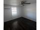Bedroom showcasing modern flooring, a ceiling fan, and a bright window at 4395 E Michigan St # 4395, Orlando, FL 32812