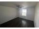 Bright bedroom featuring modern flooring, a ceiling fan, and a window for natural light at 4395 E Michigan St # 4395, Orlando, FL 32812