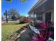 Cozy home exterior with a screened-in porch and mature landscaping at 4395 E Michigan St # 4395, Orlando, FL 32812