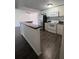 Well-lit kitchen features updated appliances, light cabinets, and stylish flooring at 4395 E Michigan St # 4395, Orlando, FL 32812