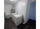 Functional laundry room featuring a washing machine, dryer, water heater, and sleek, dark flooring at 4395 E Michigan St # 4395, Orlando, FL 32812