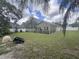 A spacious backyard features an enclosed patio and lush lawn at 2921 Blackburn Ave, Deltona, FL 32738