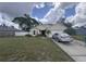 Charming single-story home with a well-manicured lawn, attached garage, and traditional architectural details at 2921 Blackburn Ave, Deltona, FL 32738