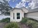 Charming exterior view showcasing the home's architectural details and a white fenced in yard with lush landscaping at 2921 Blackburn Ave, Deltona, FL 32738