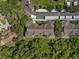 Aerial view of the building and landscaping with parking area and surrounding woods at 584 Brantley Terrace Way # 200, Altamonte Springs, FL 32714
