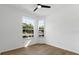 Bedroom featuring wood floors, two windows, and white walls with lots of natural light at 584 Brantley Terrace Way # 200, Altamonte Springs, FL 32714