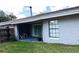 Back exterior view featuring a covered patio, a window with grid panes, a fenced yard and a potted plant at 1980 Water Ln, Maitland, FL 32751