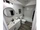 Modern bathroom featuring a subway-tiled shower, updated sink and vanity, and neutral color palette with black hardware at 1980 Water Ln, Maitland, FL 32751