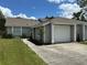 Charming one story home featuring a two car garage, gray siding, and manicured landscaping at 1980 Water Ln, Maitland, FL 32751