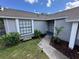 This front yard features well manicured landscaping and a concrete walkway to the home's entrance at 1980 Water Ln, Maitland, FL 32751