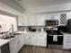 Bright updated kitchen with modern stainless steel appliances and white cabinetry at 1980 Water Ln, Maitland, FL 32751