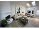 Bright living room boasts vaulted ceilings with skylights, fireplace and modern decor at 1980 Water Ln, Maitland, FL 32751