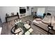 Comfortable living area with modern furniture, wood flooring, fireplace and a glass dining table that receives plenty of natural light at 1980 Water Ln, Maitland, FL 32751