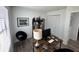 Home office featuring a computer desk setup, comfortable chair, storage shelves, and natural light from a window at 1980 Water Ln, Maitland, FL 32751