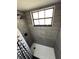 This upgraded shower features contemporary tiling, a rain shower head, and sleek black fixtures at 1980 Water Ln, Maitland, FL 32751