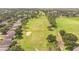 Aerial view of homes and a pristine golf course, offering scenic views and leisure activities at 2000 Farmington Ct, Clermont, FL 34711